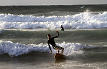 A Palestinian youth practises his sport ( riding the waves ) during sunset in Gaza city beach on Dec. 6,2010. Photo by Ashraf Amra