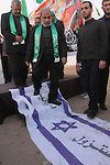 Hamas leader Mahmud al-Zahar walks on an an Israeli flag reading in Arabic 