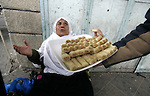 Palestinians distribute desserts celebrating the attack at the Jewish settlement of Itmar near Nablus in Rafah on March 12, 2011. A Palestinian infiltrated Itamar early Saturday and killed five people, the Israeli military said. Photo by Abed Rahim Khatib